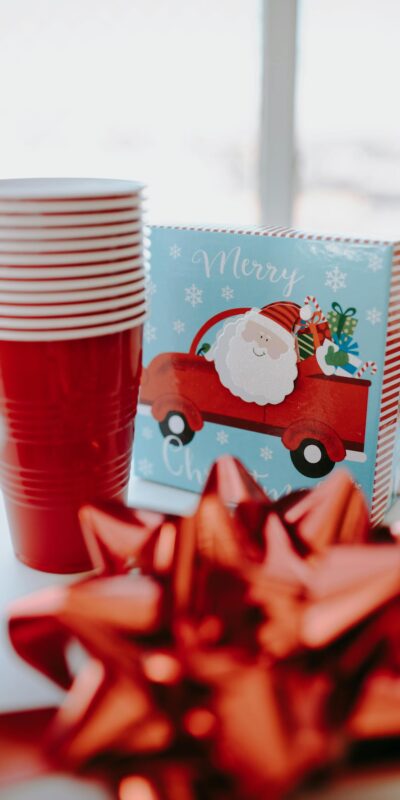 Bright Christmas-themed table setting with red accents and Santa illustration.
