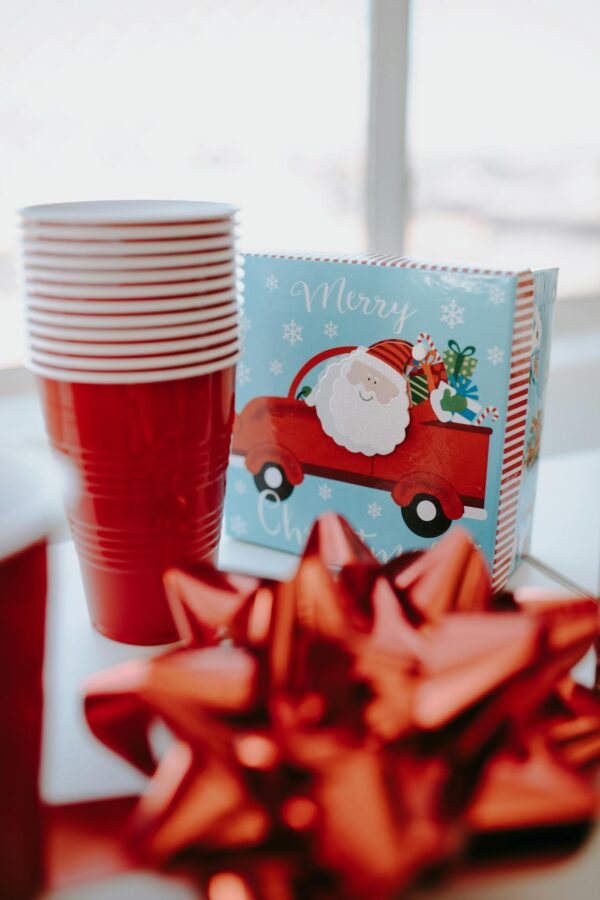 Bright Christmas-themed table setting with red accents and Santa illustration.