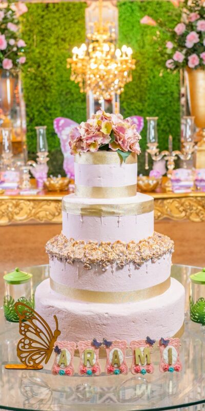 Celebrate in style with an elegant quinceañera, featuring a tiered cake and beautiful floral arrangements.