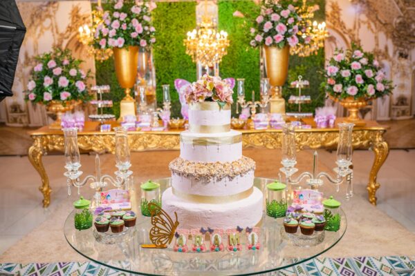 Celebrate in style with an elegant quinceañera, featuring a tiered cake and beautiful floral arrangements.